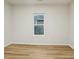 Neutral bedroom has wood-look flooring, a window, and fresh white paint throughout at 1423 Roseland Dr, Lincolnton, NC 28092