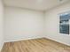 Empty bedroom with light wood laminate flooring, bright white paint, and large window at 1423 Roseland Dr, Lincolnton, NC 28092