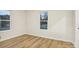 Bedroom with laminate wood-look flooring, two windows, and freshly painted walls at 1423 Roseland Dr, Lincolnton, NC 28092