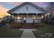 Charming home featuring inviting front porch, wood steps, and well-maintained lawn at 1423 Roseland Dr, Lincolnton, NC 28092