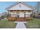 Charming home featuring a welcoming front porch with wooden accents and a well-manicured lawn at 1423 Roseland Dr, Lincolnton, NC 28092