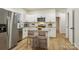 Modern kitchen featuring stainless steel appliances, white cabinets, and a central island with seating at 1423 Roseland Dr, Lincolnton, NC 28092