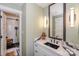 This bathroom features a modern vanity with a unique countertop and a sleek, glass-enclosed shower at 18631 Vineyard Point Ln, Cornelius, NC 28031