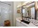 The bathroom is well-appointed, with a modern vanity, a decorative mirror, and a glass-enclosed shower at 18631 Vineyard Point Ln, Cornelius, NC 28031