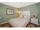 This cozy bedroom features a decorative headboard and soft pink bedding for a relaxing atmosphere at 18631 Vineyard Point Ln, Cornelius, NC 28031