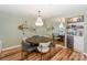 Elegant dining room with a modern chandelier, unique fish decor, and a mirrored wall that adds depth to the space at 18631 Vineyard Point Ln, Cornelius, NC 28031