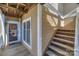 Inviting entrance with a wooden staircase leading to a well-maintained exterior with a front door and a large window at 18631 Vineyard Point Ln, Cornelius, NC 28031