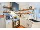 Modern kitchen with custom cabinets, quartz countertops, stainless steel appliances, and decorative open shelving at 18631 Vineyard Point Ln, Cornelius, NC 28031