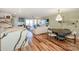Bright, open living room featuring a modern kitchen, dining area, fireplace, and a balcony with stunning views at 18631 Vineyard Point Ln, Cornelius, NC 28031