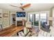 Comfortable living room with a fireplace, large sliding doors to a balcony, and a view of the water at 18631 Vineyard Point Ln, Cornelius, NC 28031