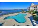 Waterfront pool with views of the lake and surrounding landscaping at 18631 Vineyard Point Ln, Cornelius, NC 28031