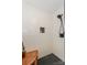 Enjoy this walk-in shower featuring modern fixtures, white tiled walls, and a convenient corner bench at 18631 Vineyard Point Ln, Cornelius, NC 28031