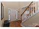 Bright and spacious entryway with hardwood floors, staircase, and coat bench at 1908 Robbins Meadows Dr, Waxhaw, NC 28173