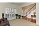 Spacious living room with a fireplace, hardwood floors, and access to other rooms at 1908 Robbins Meadows Dr, Waxhaw, NC 28173