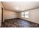 This bedroom features wood-look floors, two windows, and neutral walls at 3553 33Rd Street Ne Dr, Hickory, NC 28601