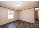 Bedroom featuring wood-look floors, a window, and partially seen ensuite bath at 3553 33Rd Street Ne Dr, Hickory, NC 28601