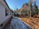 Side view of the home showing light gray siding, black shutters, and tree-lined surroundings at 3553 33Rd Street Ne Dr, Hickory, NC 28601