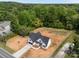 Aerial view of a home situated on a spacious lot surrounded by lush trees at 5037 Faith Rd, Salisbury, NC 28146