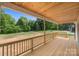 Inviting covered back porch with wood ceiling, perfect for outdoor relaxation at 5037 Faith Rd, Salisbury, NC 28146