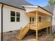 Charming back porch with stairs, ideal for enjoying the outdoor scenery at 5037 Faith Rd, Salisbury, NC 28146