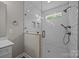 Modern bathroom featuring a glass-enclosed shower with white subway tile and matte black hardware at 5037 Faith Rd, Salisbury, NC 28146