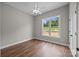 Cozy bedroom boasts hardwood floors, ceiling fan, and a bright window showcasing the green lawn at 5037 Faith Rd, Salisbury, NC 28146