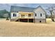 Exterior view of the back of the home showing the siding, deck, and foundation at 5037 Faith Rd, Salisbury, NC 28146