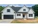 Charming new construction home featuring a white exterior, black shutters, and a spacious two-car garage at 5037 Faith Rd, Salisbury, NC 28146