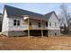 Rear view of a new construction home featuring a deck and brickwork at 5037 Faith Rd, Salisbury, NC 28146