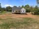 Exterior view of the back of the home showing the siding, deck, and yard at 5037 Faith Rd, Salisbury, NC 28146