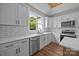 Bright kitchen featuring stainless steel appliances, modern white cabinets, and hardwood floors at 5037 Faith Rd, Salisbury, NC 28146