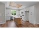 Kitchen boasts modern white cabinets, island, and stainless appliances, all under a wood ceiling at 5037 Faith Rd, Salisbury, NC 28146