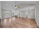 Open living room features hardwood floors with view into kitchen and stainless appliances at 5037 Faith Rd, Salisbury, NC 28146