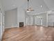Spacious living room with fireplace, hardwood floors, and view into the kitchen area at 5037 Faith Rd, Salisbury, NC 28146