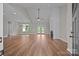 Open living room features hardwood floors, a ceiling fan, and french doors to backyard at 5037 Faith Rd, Salisbury, NC 28146