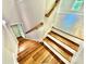 Wooden staircase leading to a lower level with access to an additional room at 5037 Faith Rd, Salisbury, NC 28146