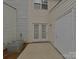 This is a backyard featuring a concrete patio, double doors, and vinyl siding at 1826 Birch Heights Ct, Charlotte, NC 28213