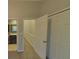 Hallway view featuring an open doorway leading to a bathroom, closet doors, and railing at 1826 Birch Heights Ct, Charlotte, NC 28213