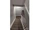 A staircase leading to the basement is carpeted with white railing and gray walls at 1826 Birch Heights Ct, Charlotte, NC 28213
