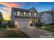 Charming two-story home with brick and vinyl siding and a well-manicured front yard at 2155 Galloway Ln, Concord, NC 28025