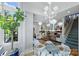 Sunlit breakfast nook with a glass-top table and view into living room at 2408 Westfield Rd, Charlotte, NC 28207