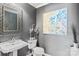 Stylish powder room featuring a decorative mirror, vanity, and elegant artwork at 2425 Birdie Ne Ln, Conover, NC 28613