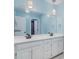 A clean and modern bathroom featuring a double sink vanity and decorative lighting at 2425 Birdie Ne Ln, Conover, NC 28613