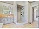 Elegant bathroom with tile flooring, a walk-in shower, a soaking tub, and a spacious vanity at 2425 Birdie Ne Ln, Conover, NC 28613