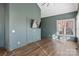 Spacious bedroom with green walls, hardwood floors, and a big window letting in natural light at 2425 Birdie Ne Ln, Conover, NC 28613