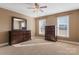 Carpeted bedroom featuring two dressers, two windows, ceiling fan, and neutral colored walls at 2425 Birdie Ne Ln, Conover, NC 28613