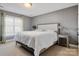 This bedroom is carpeted and has a neutral decor and large window at 2425 Birdie Ne Ln, Conover, NC 28613
