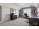 Cozy carpeted bedroom featuring a window, dark grey walls, and University of Alabama sports memorabilia at 2425 Birdie Ne Ln, Conover, NC 28613
