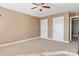 This bedroom is carpeted and features neutral walls, a ceiling fan, and two closets at 2425 Birdie Ne Ln, Conover, NC 28613