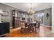 Formal dining area with wood table, chairs, hutch, and hardwood floors at 2425 Birdie Ne Ln, Conover, NC 28613